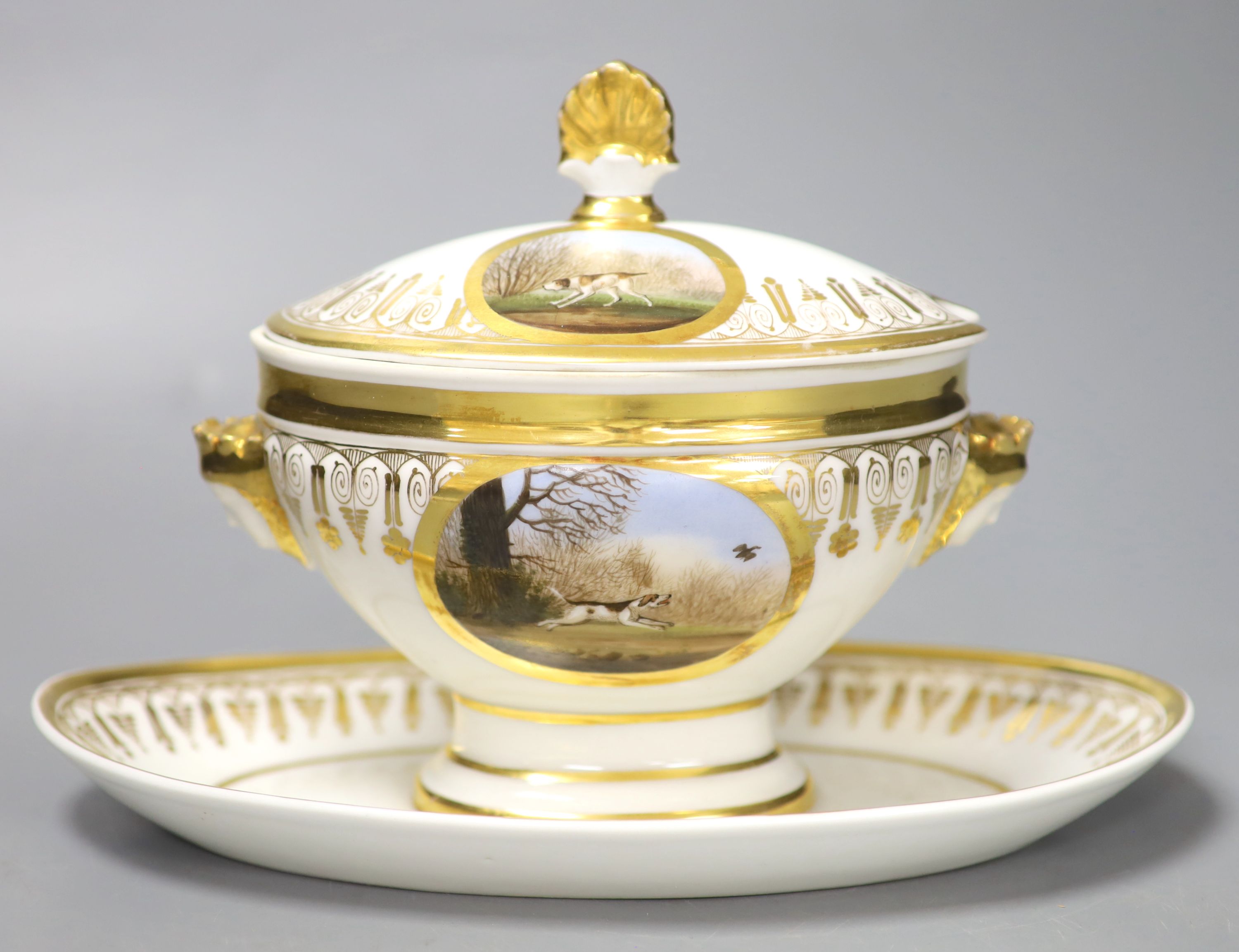 A Paris porcelain tureen and cover highly gilded and painted with four oval panels, two with dogs, one with a stag and one with two har